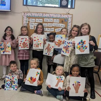 Children sharing Sunday School art projects